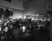 Customers do their Christmas shopping in semi-darkness during an electricity strike in December 1973. 