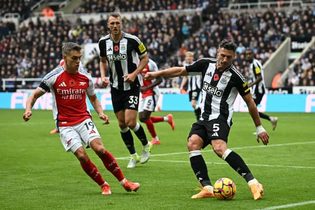 Newcastle United's Swiss defender #05 Fabian Schar (R) clears the ball under pressure from Arsenal's Belgian midfielder #19 Leandro Trossard (L) during the English Premier League football match between Newcastle United and Arsenal at St James' Park in Newcastle-upon-Tyne, north east England on November 2, 2024. (Photo by Paul ELLIS / AFP) /