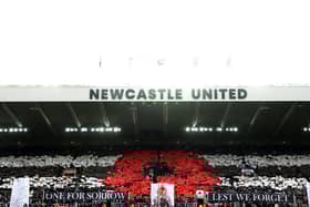 General view inside the stadium as fans display a mosaic of a poppy and banners reading "One For Sorrow" and "Lest We Forget" as they observe a minutes silence ahead of Remembrance Day prior to the Premier League match between Newcastle United FC and Arsenal FC at St James' Park on November 02, 2024 in Newcastle upon Tyne, England. (Photo by George Wood/Getty Images)