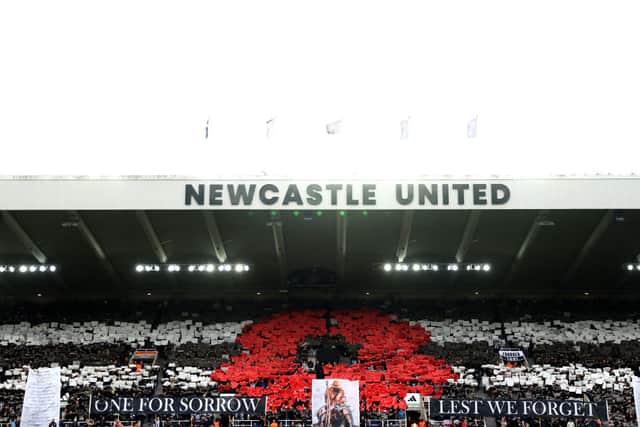 General view inside the stadium as fans display a mosaic of a poppy and banners reading "One For Sorrow" and "Lest We Forget" as they observe a minutes silence ahead of Remembrance Day prior to the Premier League match between Newcastle United FC and Arsenal FC at St James' Park on November 02, 2024 in Newcastle upon Tyne, England. (Photo by George Wood/Getty Images)