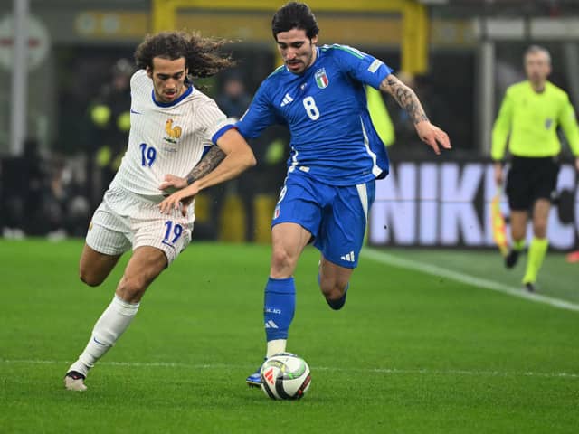 France's midfielder #19 Matteo Guendouzi (L) fights for the ball with Italy's midfielder #08 Sandro Tonali during the Nations League group A2 football match between Italy and France at San Siro stadium in Milan, on November 17, 2024. (Photo by Alberto PIZZOLI / AFP) (Photo by ALBERTO PIZZOLI/AFP via Getty Images)