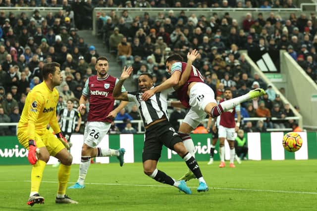 Callum Wilson of Newcastle United is tackled by Konstantinos Mavropanos of West Ham United during the Premier League match between Newcastle United FC and West Ham United FC at St James' Park on November 25, 2024 in Newcastle upon Tyne, England. (Photo by Carl Recine/Getty Images)