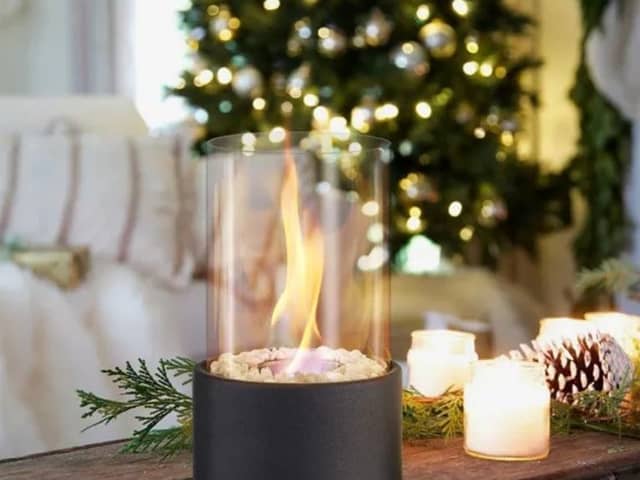 The fireplace can sit in any room, giving off heat and setting a festive mood