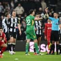 Nick Pope of Newcastle United reacts as he is shown a yellow card by Referee Andy Madley during the Premier League match between Newcastle United FC and Liverpool FC at St James' Park on December 04, 2024 in Newcastle upon Tyne, England. (Photo by Stu Forster/Getty Images)