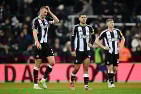 Dan Burn, Bruno Guimaraes and Lewis Hall of Newcastle United react after drawing with Liverpool during the Premier League match between Newcastle United FC and Liverpool FC at St James' Park on December 04, 2024 in Newcastle upon Tyne, England. (Photo by Stu Forster/Getty Images)