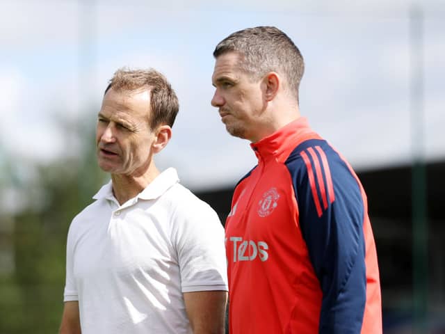 Dan Ashworth speaks to Manager Marc Skinner of Manchester United Women in action during a training session at St Georges Park on August 09, 2024 in Burton-upon-Trent, England.  (Photo by Charlotte Tattersall - MUFC/Manchester United via Getty Images)