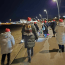 More than 100 people took part in a Christmas walk to raise funds for a cancer charity.