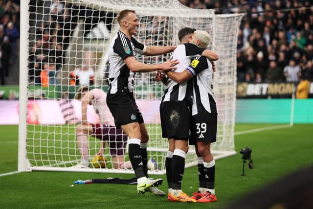 Fabian Schar of Newcastle United celebrates scoring his team's third goal with teammates Dan Burn and Bruno Guimaraes. (Photo by Carl Recine/Getty Images)
