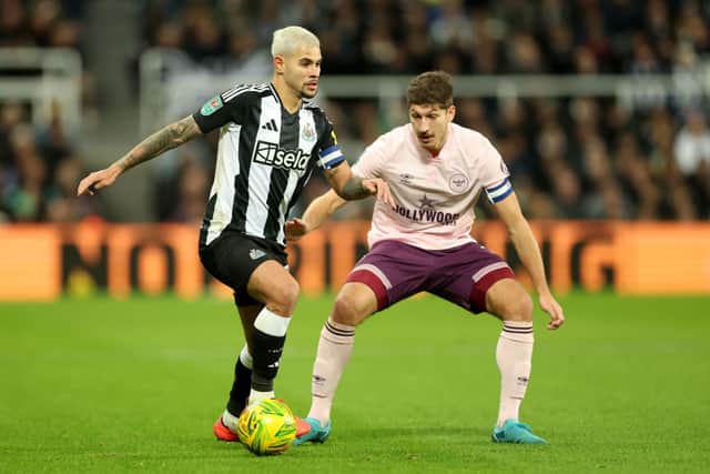 Bruno Guimaraes of Newcastle United controls the ball whilst under pressure from Vitaly Janelt of Brentford in the Carabao Cup  (Photo by Carl Recine/Getty Images)
