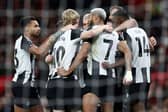 Newcastle United's Swedish striker #14 Alexander Isak (R) is mobbed by teammates after scoring the opening goal during the English Premier League football match between Manchester United and Newcastle United at Old Trafford in Manchester, north west England, on December 30, 2024. (Photo by Darren Staples / AFP) 