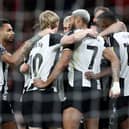Newcastle United's Swedish striker #14 Alexander Isak (R) is mobbed by teammates after scoring the opening goal during the English Premier League football match between Manchester United and Newcastle United at Old Trafford in Manchester, north west England, on December 30, 2024. (Photo by Darren Staples / AFP) 