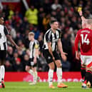 Fabian Schar of Newcastle United is shown a yellow card by referee Simon Hooper during the Premier League match between Manchester United FC and Newcastle United FC at Old Trafford on December 30, 2024 in Manchester, England. (Photo by Stu Forster/Getty Images)
