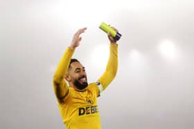Matheus Cunha of Wolverhampton Wanderers shows appreciation to the fans whilst holding the player of the match award following victory in the Premier League match between Wolverhampton Wanderers FC and Manchester United FC at Molineux on December 26, 2024 in Wolverhampton, England.