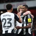 Alexander Isak of Newcastle United celebrates with teammates Anthony Gordon and Jacob Murphy after scoring his team's first goal during the Carabao Cup Semi Final First Leg match between Arsenal and Newcastle United at Emirates Stadium on January 07, 2025 in London, England. (Photo by Alex Pantling/Getty Images)