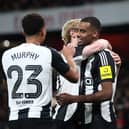 Alexander Isak of Newcastle United celebrates with teammates Anthony Gordon and Jacob Murphy after scoring his team's first goal during the Carabao Cup Semi Final First Leg match between Arsenal and Newcastle United at Emirates Stadium on January 07, 2025 in London, England. (Photo by Alex Pantling/Getty Images)