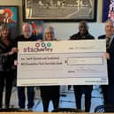 Maureen Summerill, Michael Ganley of the Fans Museum, Emma Scott, Directorate Manager Urology, Gary Bennett and Stuart McCracken, Clinical Director for Urology, with the cheque presented to the trust's charity.