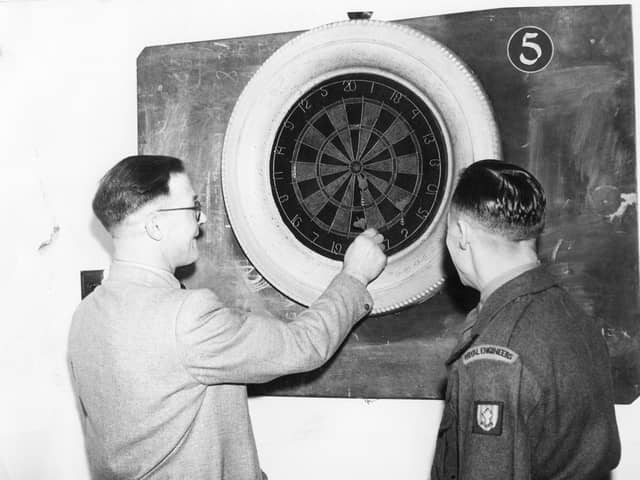 A game of darts for these two at Frenchman's Fort in January 1955.