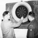 A game of darts for these two at Frenchman's Fort in January 1955.