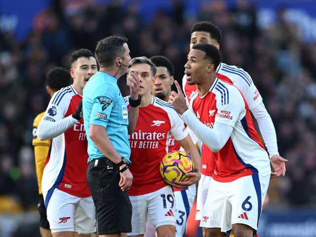 Gabriel of Arsenal and his teammates protest to Referee Michael Oliver after Myles Lewis-Skelly of Arsenal (not pictured) is shown a red card for a foul on Matt Doherty of Wolverhampton Wanderers (not pictured) during the Premier League match between Wolverhampton Wanderers FC and Arsenal FC at Molineux.