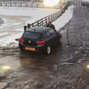 The moment Alan Lewis drove off with the staff member on the bonnet of the car. Credit: Mainsgill Farm Shop