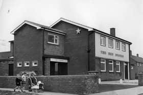 These little ones were out for a walk with their toy pram when they went past the Red Duster pub in 1964.