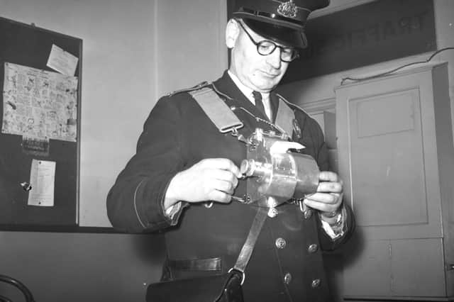 William Glendenning was testing a new style ticket machine when this photo was taken in 1952.