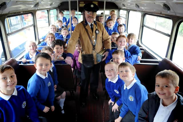South Shields Bus Preservation Society bus conductor Barry Dobson, with pupils from Westoe Crown Primary School.
