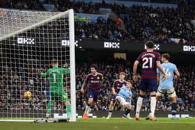 James McAtee of Manchester City scores his team's fourth goal during the Premier League match between Manchester City FC and Newcastle United FC at Etihad Stadium on February 15, 2025 in Manchester, England. (Photo by Carl Recine/Getty Images)