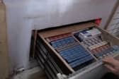 Criminals had built a secret room behind a fake radiator which hid a deep drawer full of illegal tobacco products. 