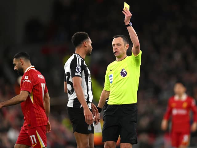 Stuart Attwell booking Jacob Murphy during Liverpool's win over Newcastle United