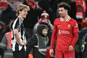 Newcastle United's English midfielder #10 Anthony Gordon (L) and Liverpool's English midfielder #17 Curtis Jones react at the final whistle during the English Premier League football match between Liverpool and Newcastle United at Anfield in Liverpool, north west England on February 26, 2025. Liverpool won the match 2-0. (Photo by Paul ELLIS / AFP)    