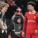 Newcastle United's English midfielder #10 Anthony Gordon (L) and Liverpool's English midfielder #17 Curtis Jones react at the final whistle during the English Premier League football match between Liverpool and Newcastle United at Anfield in Liverpool, north west England on February 26, 2025. Liverpool won the match 2-0. (Photo by Paul ELLIS / AFP)    