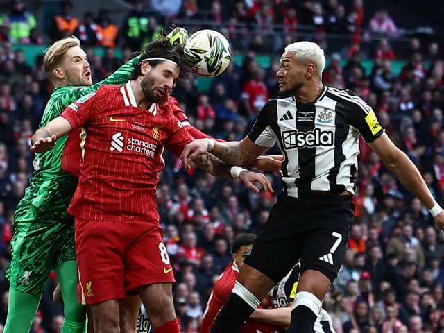 Joelinton challenges for the ball with Dominik Szoboszlai and Caoimhin Kelleher. 