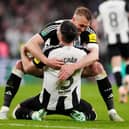 Newcastle United's Dan Burn (right) and Fabian Schar celebrate winning the Carabao Cup final at Wembley Stadium, London.