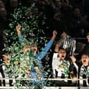 Bruno Guimaraes and Kieran Trippier lift the Carabao Cup. 