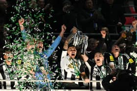 Bruno Guimaraes and Kieran Trippier lift the Carabao Cup. 