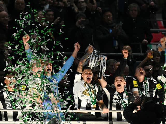Bruno Guimaraes and Kieran Trippier lift the Carabao Cup. 