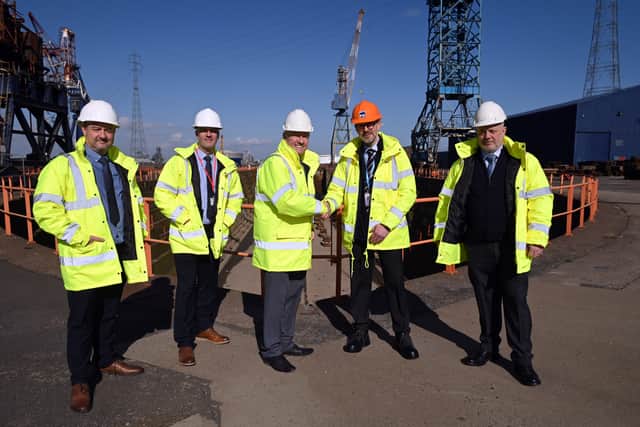 Dan Haslar, senior property manager at PD Ports, (orange hat), congratulates UK Docks founder Harry Wilson and his sons Gary, Jonathan and Chris.