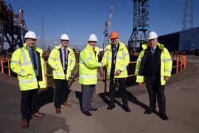 Dan Haslar, senior property manager at PD Ports, (orange hat), congratulates UK Docks founder Harry Wilson and his sons Gary, Jonathan and Chris.