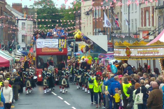 Morpeth Fair Day, with crowds lining the streets to cheer on Morpeth Town FC's players during an open top bus parade