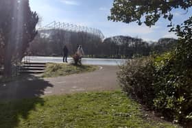 Two people in Leazes Park, Newcastle, with St James' Park in the background, where it has been rumoured Newcastle United could build a new stadium
