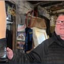 Shop owner holding an artificial leg