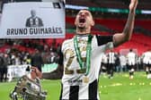 Newcastle United midfielder Bruno Guimaraes with the Carabao Cup. 