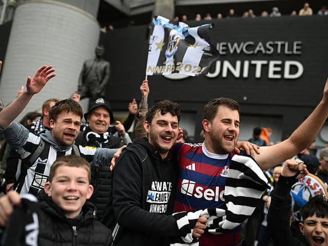 Newcastle United's fans gather beside the statue of former manager Bobby Robson ahead of an open-top bus parade by the players with the League Cup trophy through the city of Newcastle upon Tyne in north-east England on March 29, 2025, after winning the English League Cup, their first domestic trophy for 70 years. (Photo by Oli SCARFF / AFP) (Photo by OLI SCARFF/AFP via Getty Images)          