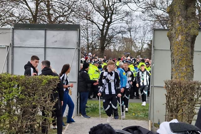 Newcastle United defender Lewis Hall on crutches.