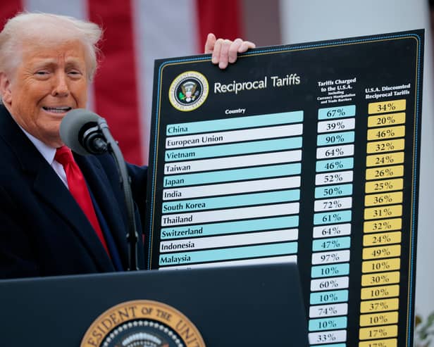 President Donald Trump holds up a chart of "reciprocal tariffs" while speaking during a trade announcement event in the Rose Garden at the White House.