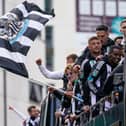 Newcastle United Football Club players and staff react to fans during an open-top bus victory parade after their success in the Carabao Cup final  on March 29, 2025 in Newcastle upon Tyne, England. Newcastle United defeated Liverpool in the Carabao Cup Final to end their seventy-year domestic trophy drought.