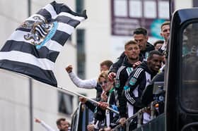 Newcastle United Football Club players and staff react to fans during an open-top bus victory parade after their success in the Carabao Cup final  on March 29, 2025 in Newcastle upon Tyne, England. Newcastle United defeated Liverpool in the Carabao Cup Final to end their seventy-year domestic trophy drought.