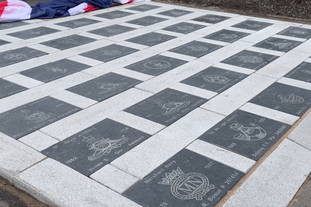 Each stone has a veteran's name, regiment and the years that they served in the armed forces.