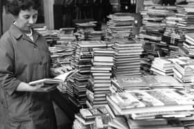 Miss Elsie Ord, schools librarian, looks at some of the new books in the South Tyneside stock in 1968.